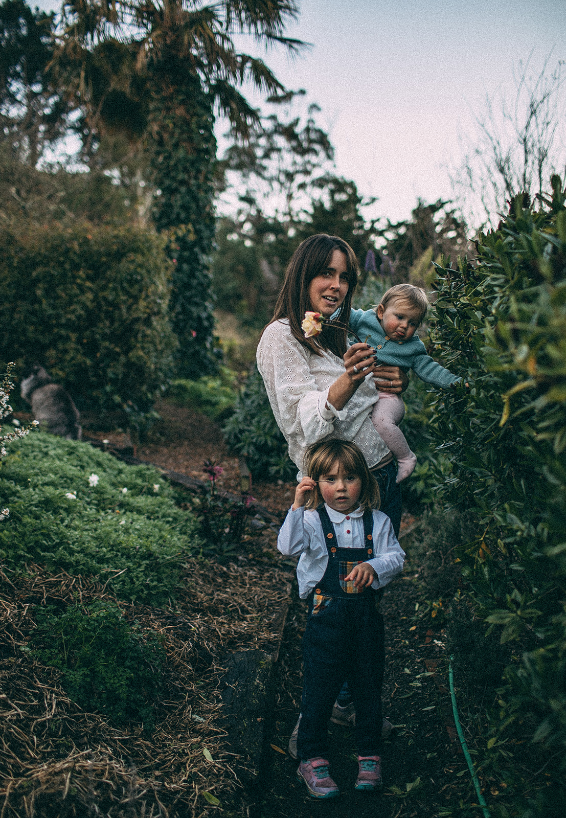 A mother and her two daughters enjoy the garden at their home in Lyttelton, Christchurch