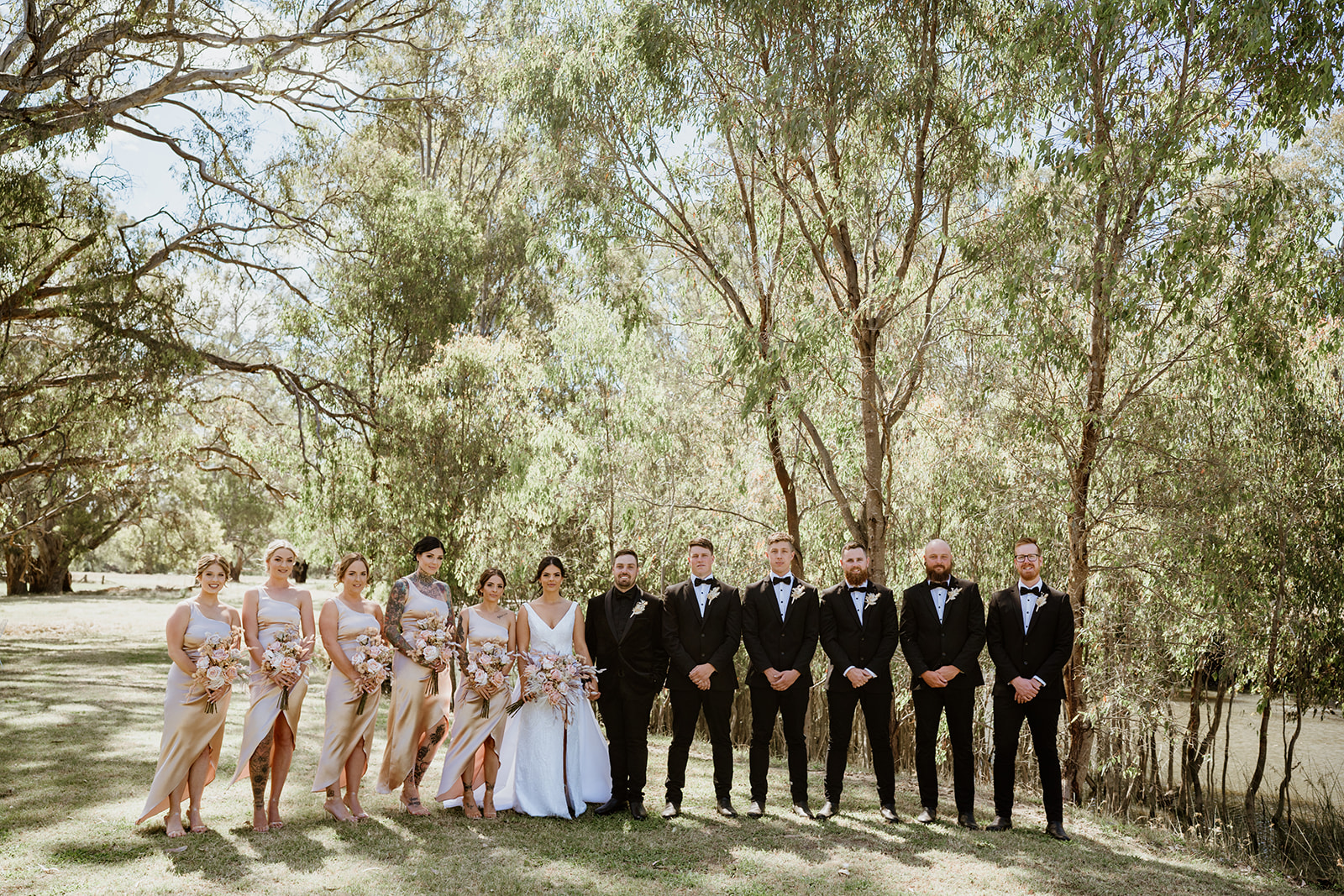 Redbank Events wedding. Bride and groom photo with bridesmaides and groomsmen. By the river wedding in Barnawartha.