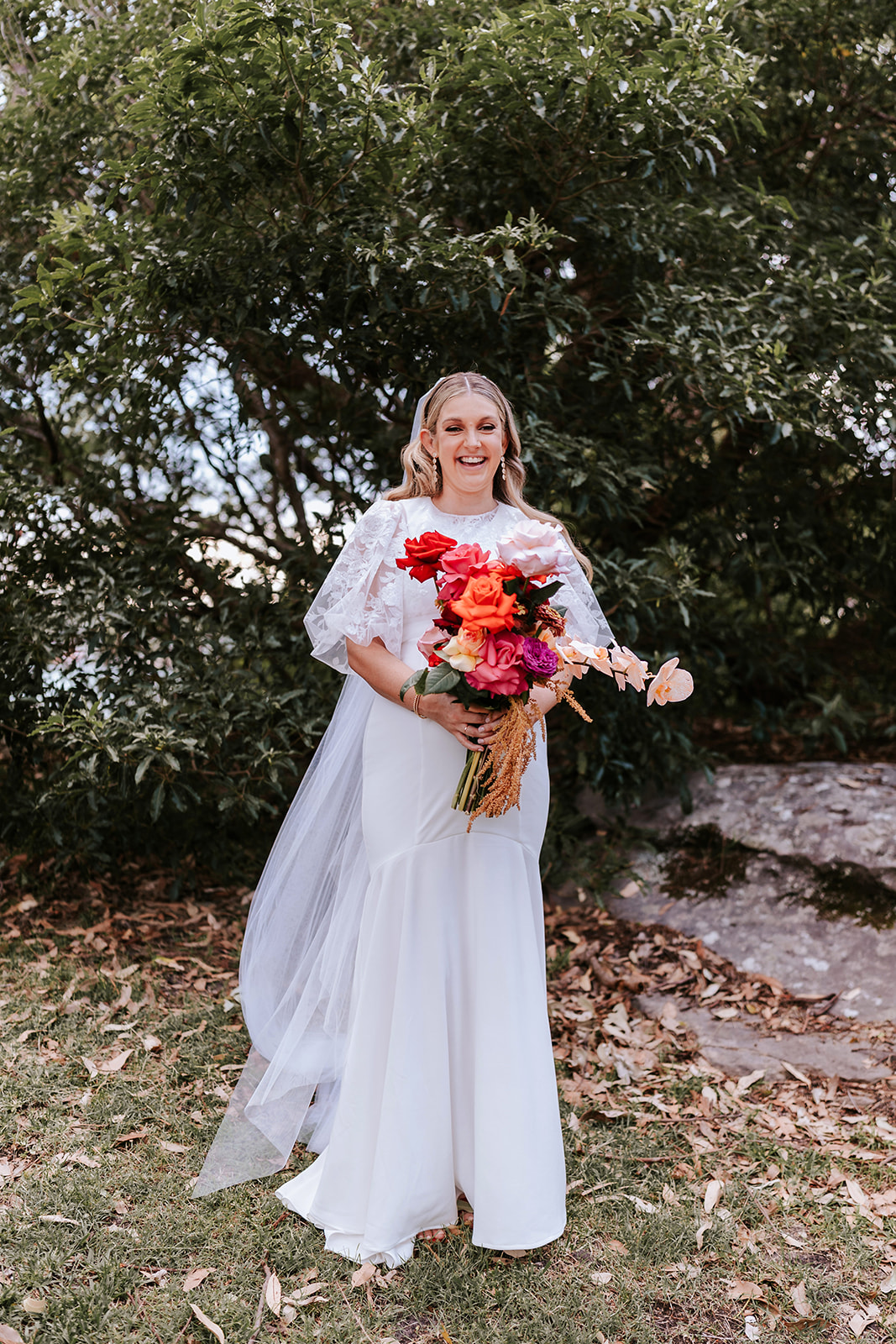 Bride holding colourful bouquet 