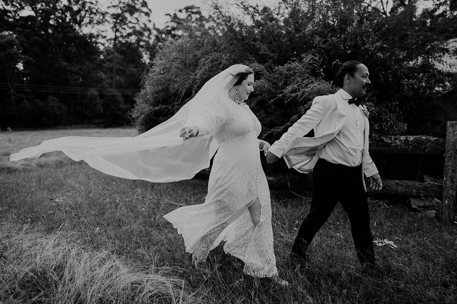 Bride and groom, walking with the veil, flowing behind bride