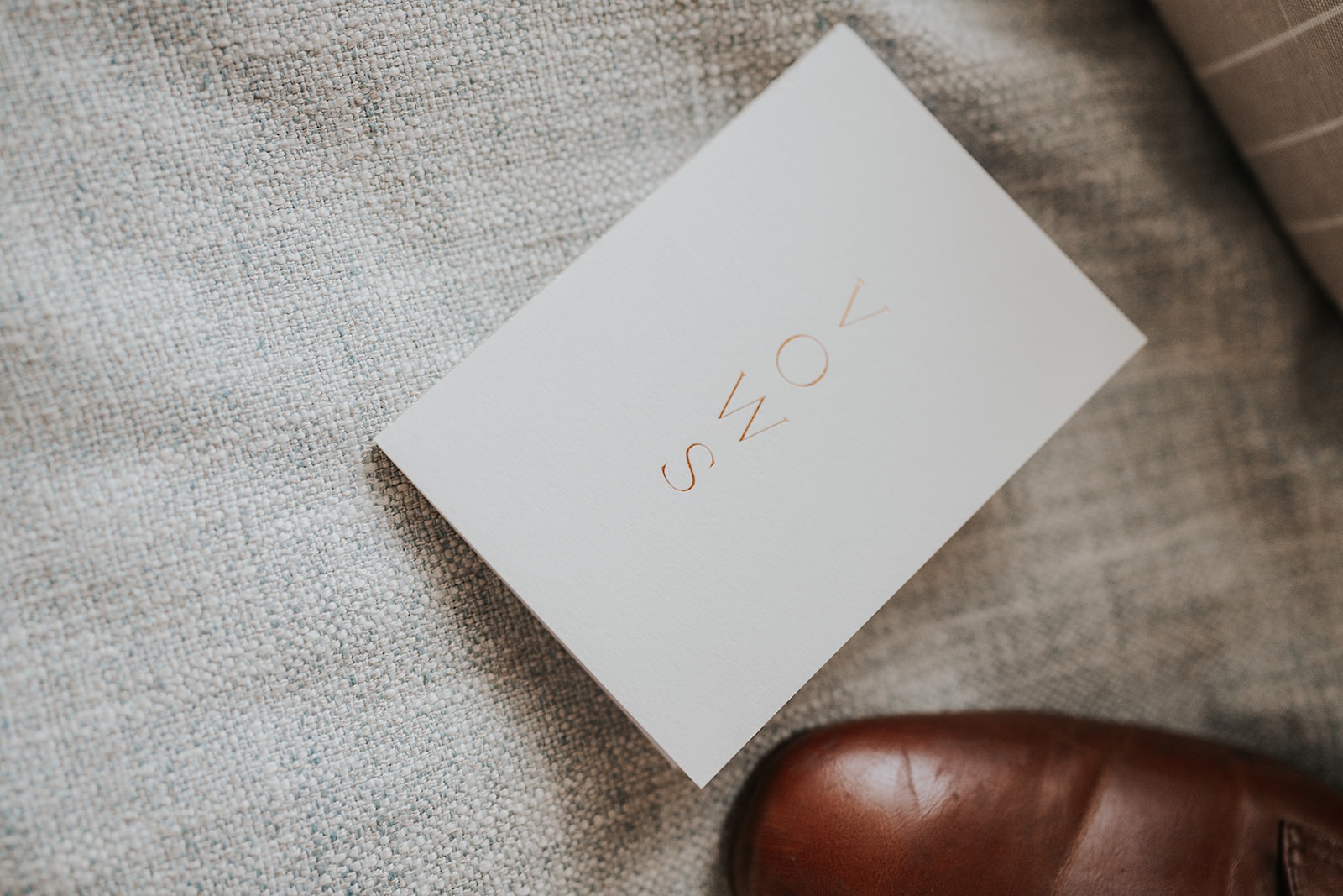 A detail photograph of a groom's vow book before the ceremony.