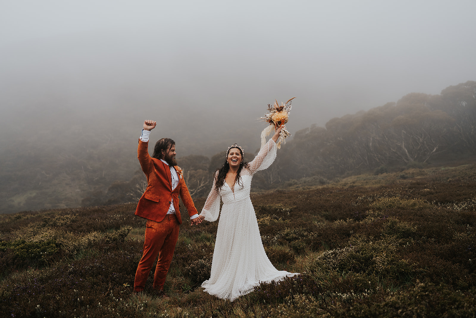 The bride and groom celebrate their elopement on Mount Hotham.