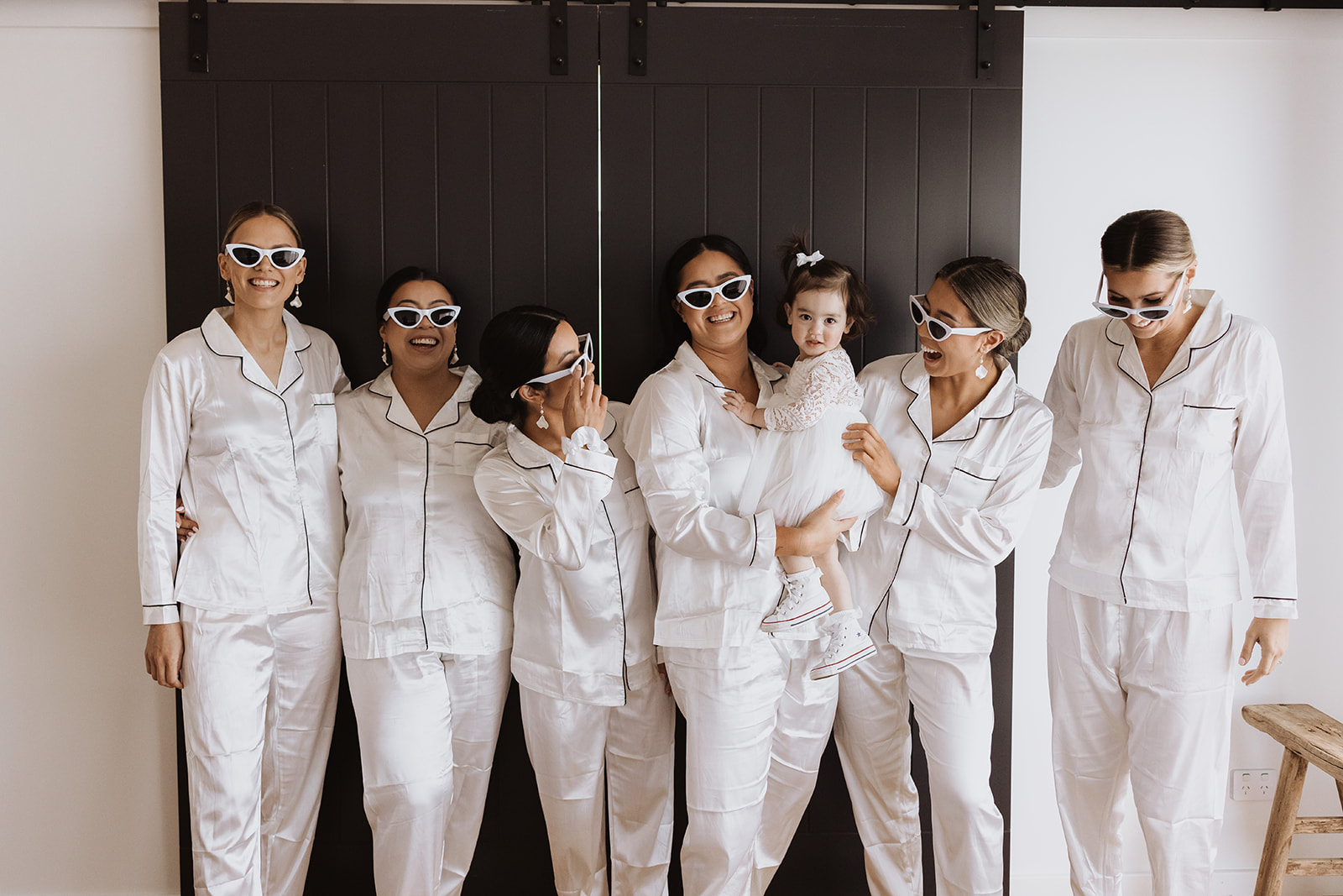 The bride with her bridesmaids wearing sunglasses 