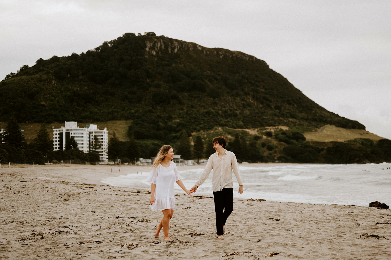 couples getting photographed on mount Maunganui beach 