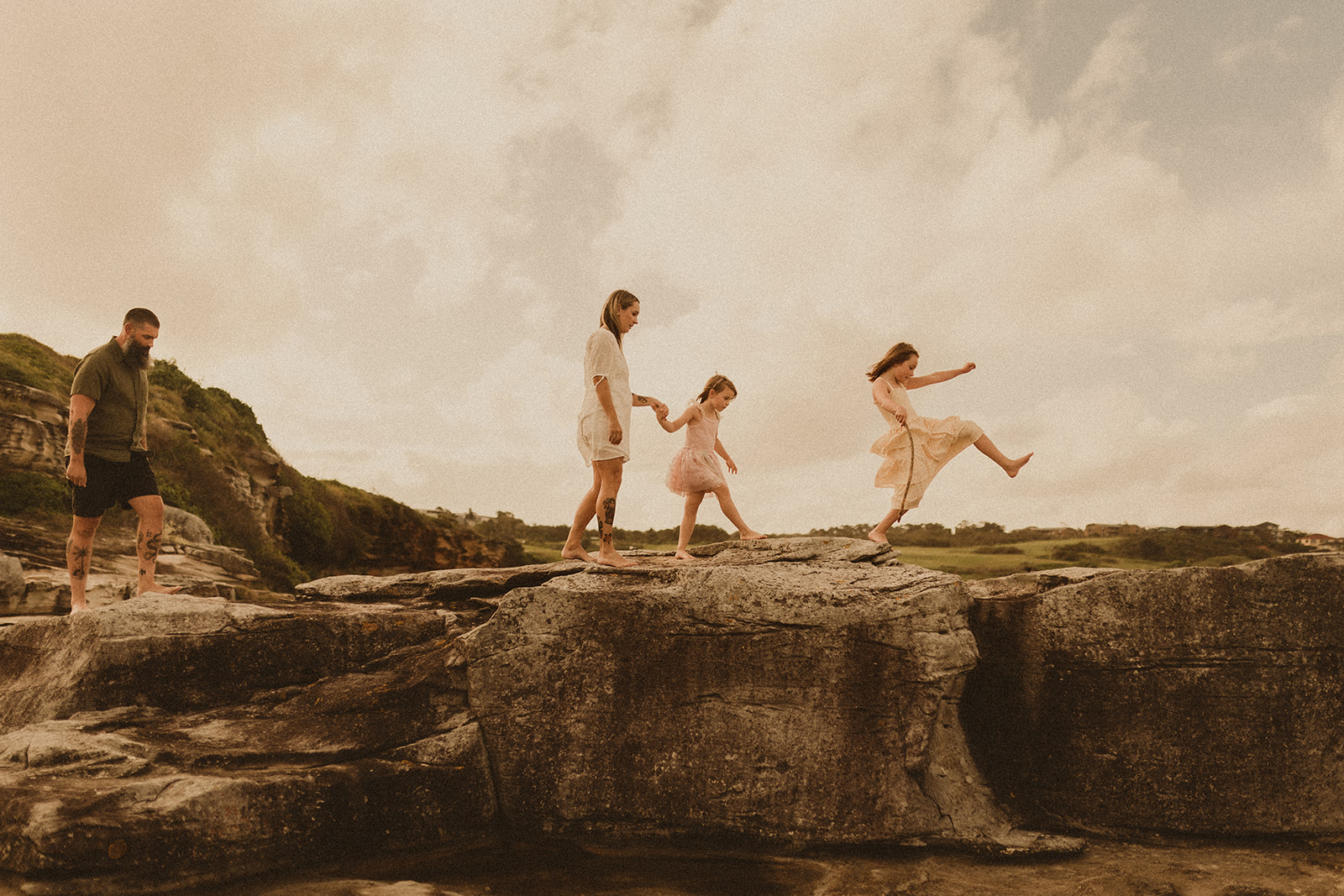 Follow the leader, family playing on rocks. Family Photography Sydney