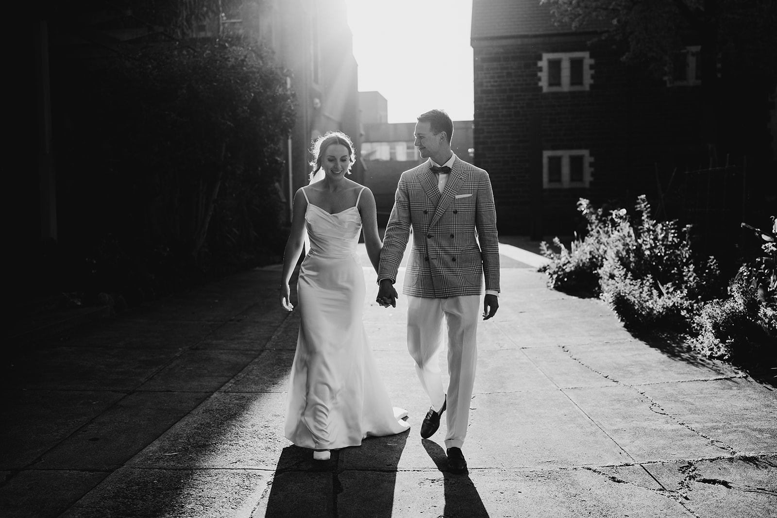 Bride and groom walking in sunset portraits captured by candid wedding photographer in Melbourne 