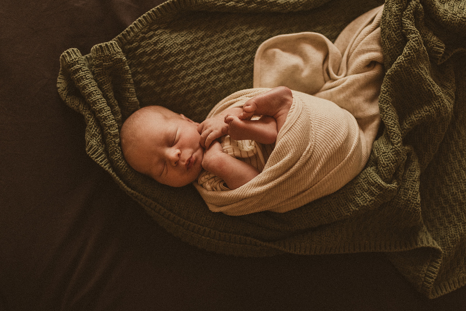 Newborn Photography Sydney. Newborn baby wrapped on bed, sleeping.