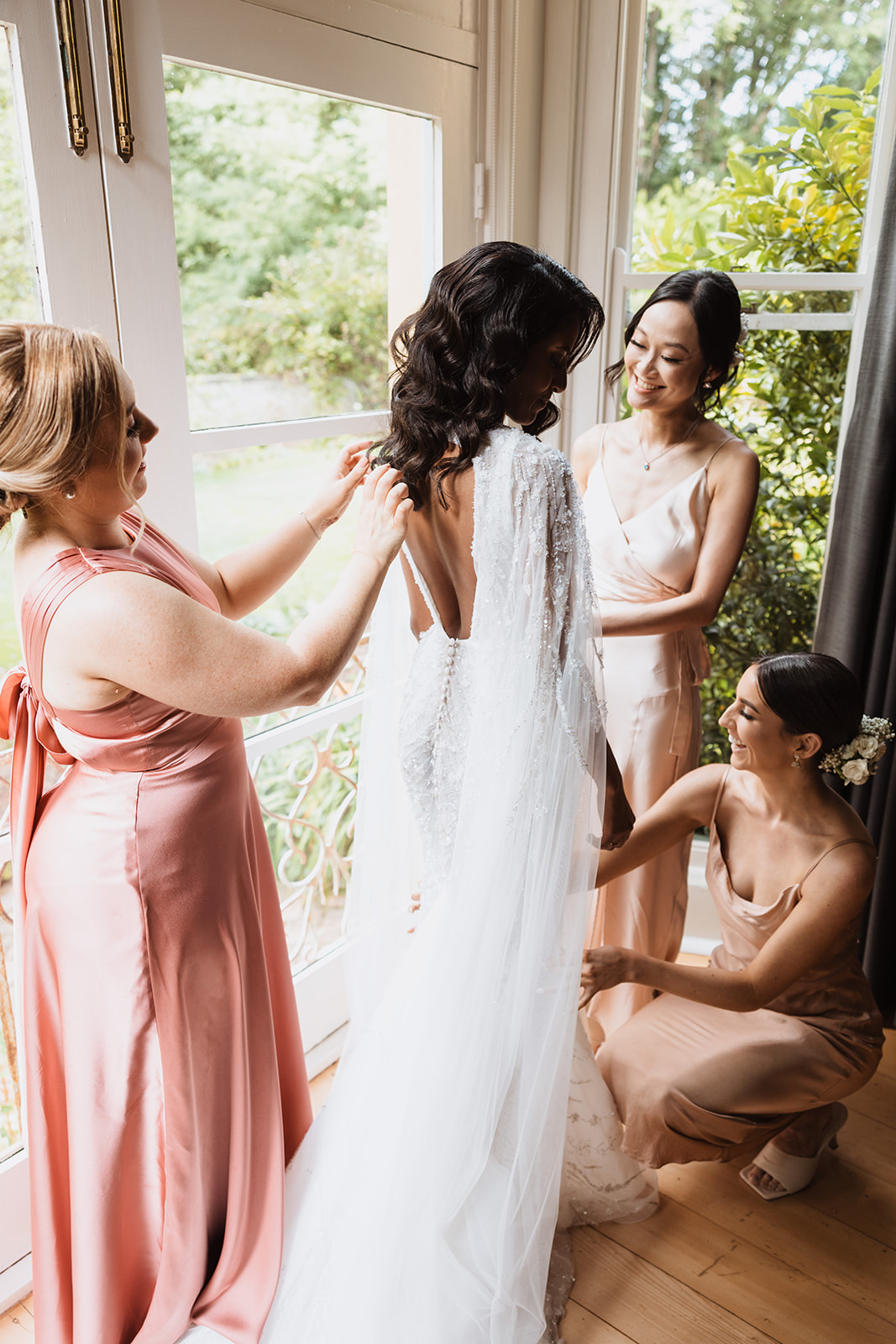 Bride and her bridesmaids fixing the gown at the Wedding in Mona Farm Braidwood, New South Wales