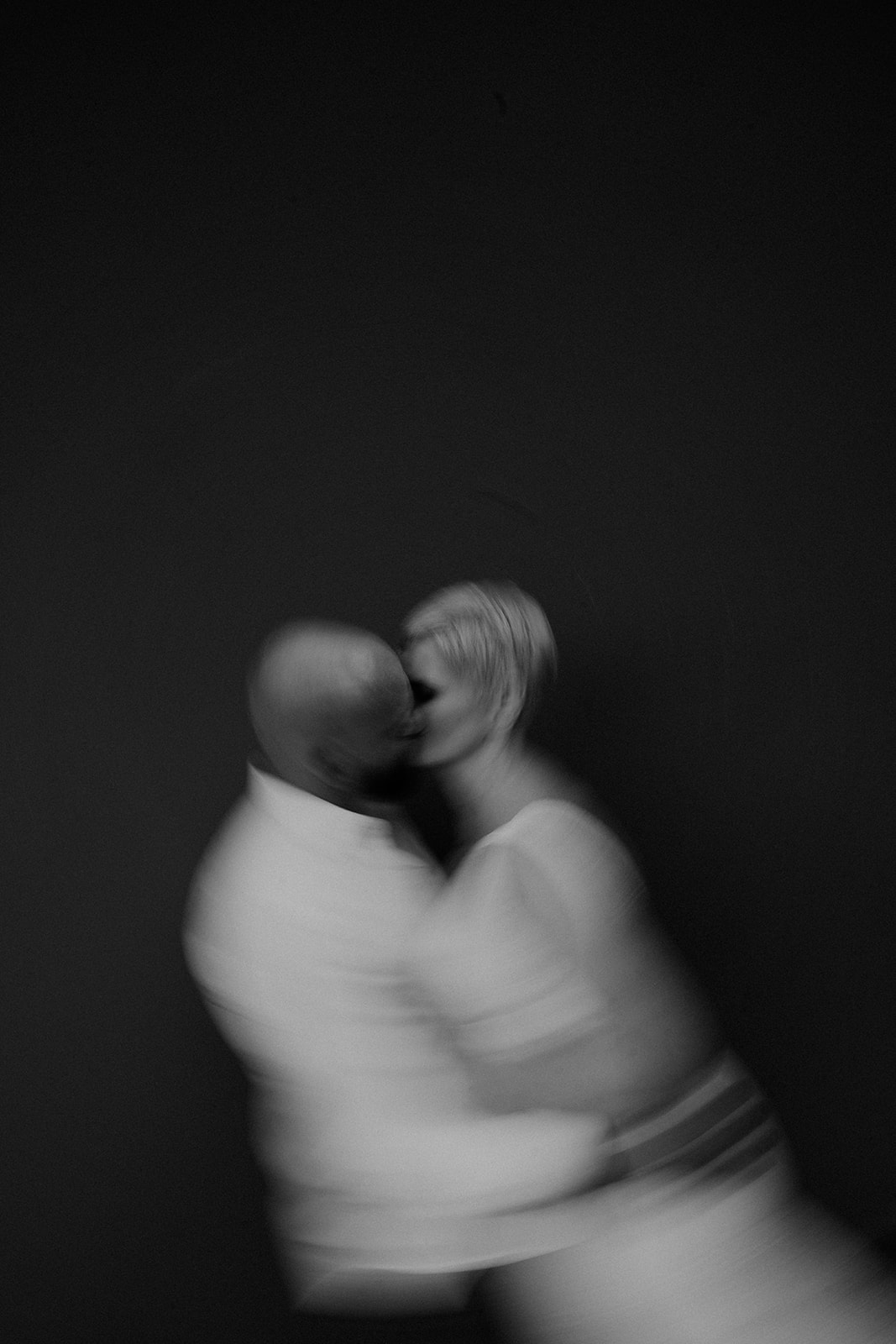 an artistic black-and-white blurred image of a bride and groom 