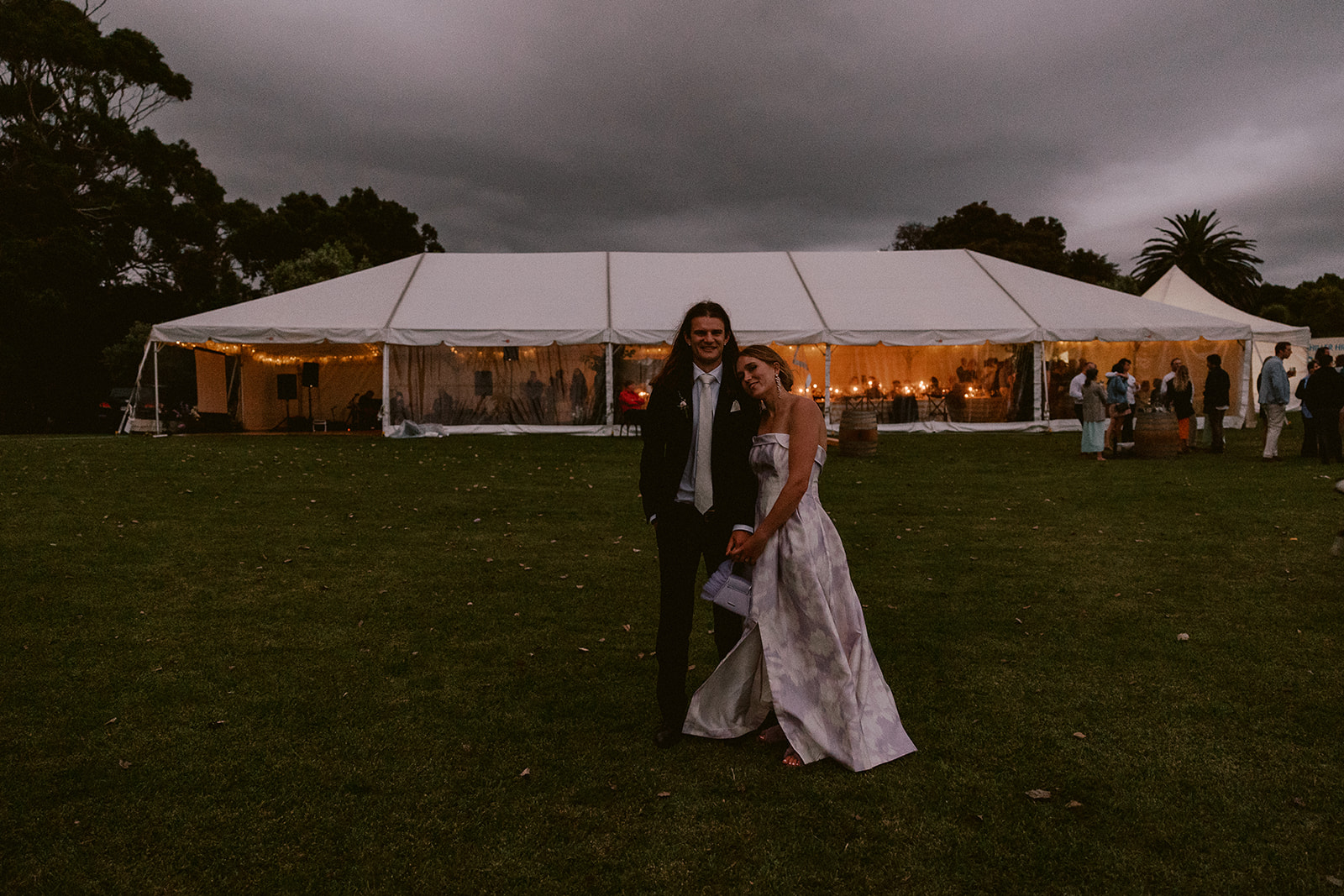 A couple standing in front of a wedding venue at Orui Station Riversdale Beach