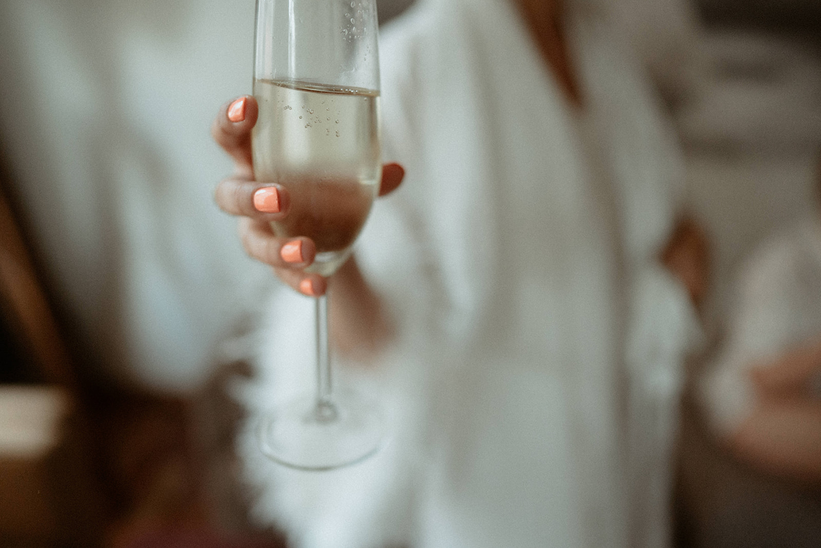Bride, holding up a champagne glass