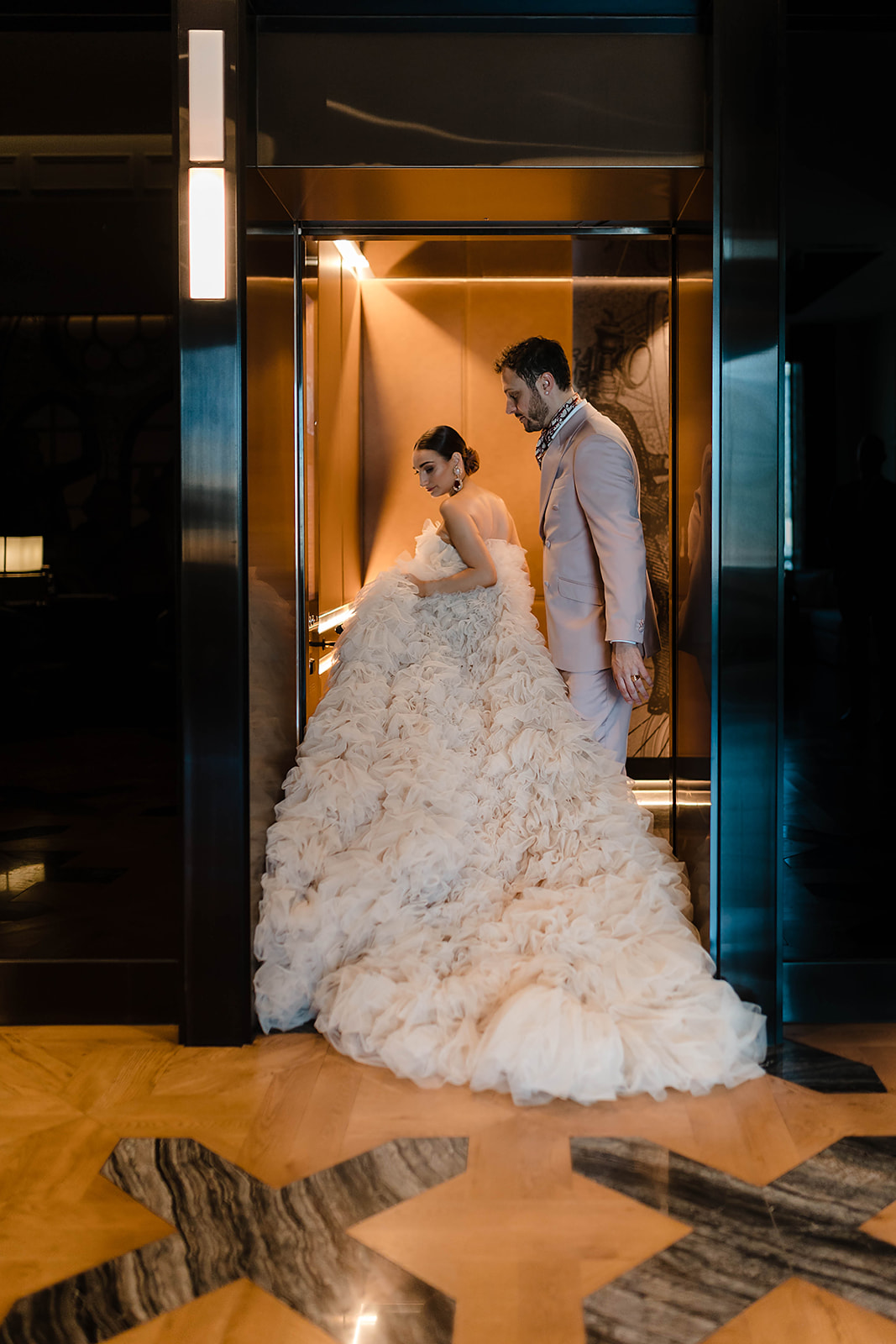 The bride and groom on the elevator of Sofitel Adelaide hotel