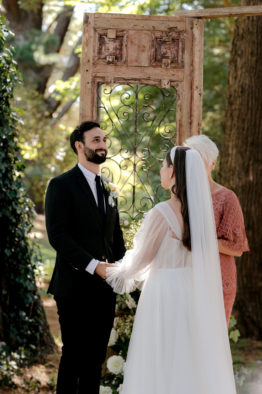 Portrait of bride & groom filled with joy at their elegant country wedding ceremony.