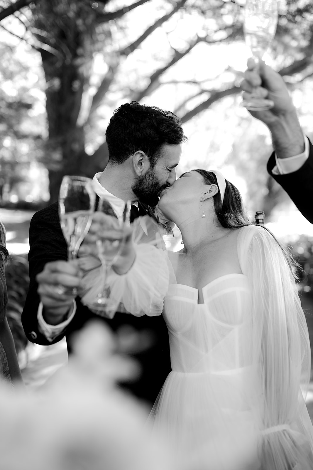 Bride & groom sipping champagne with their wedding party during their elegant country wedding.