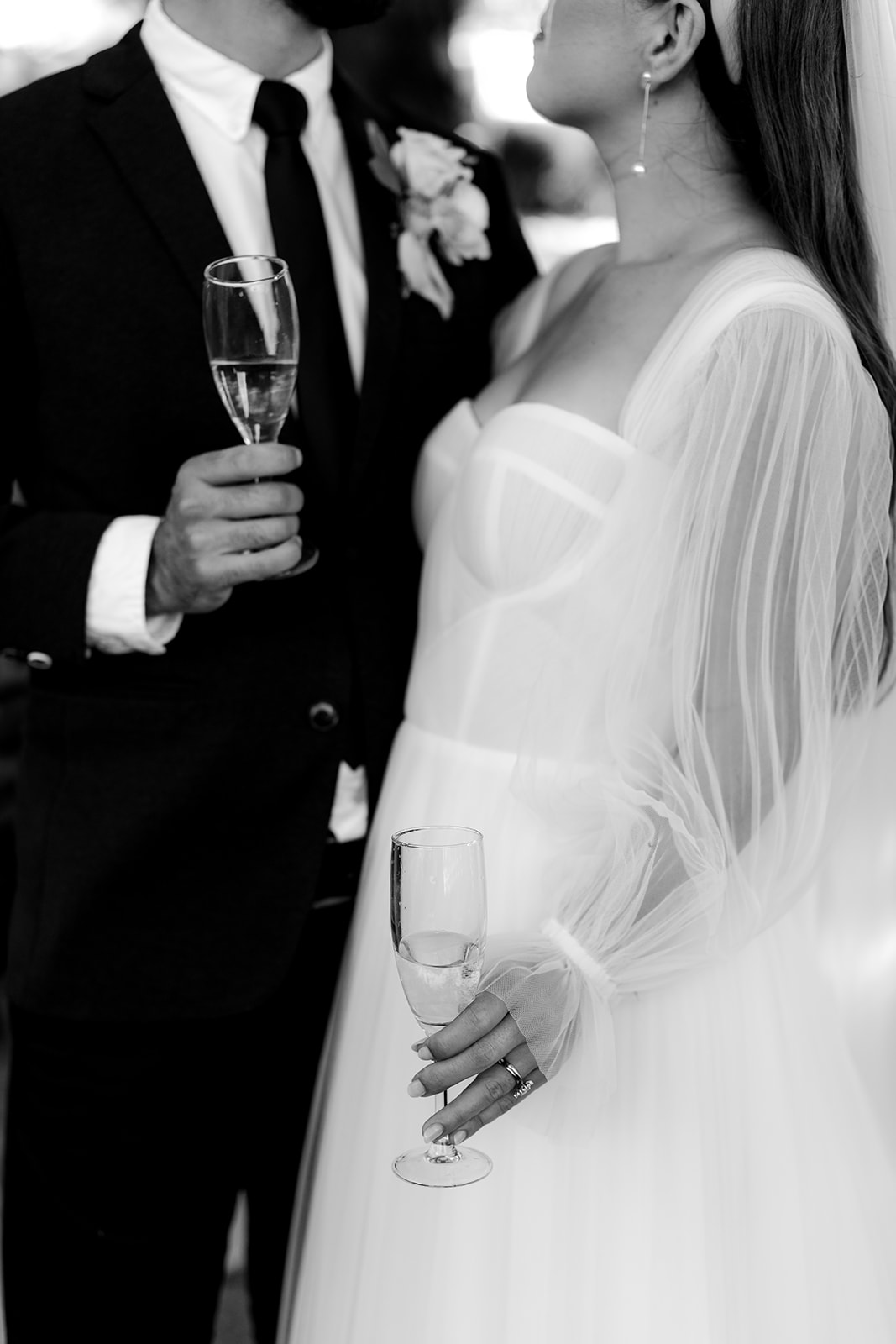 Close-up of bride & groom enjoying some champagne at their elegant country wedding.