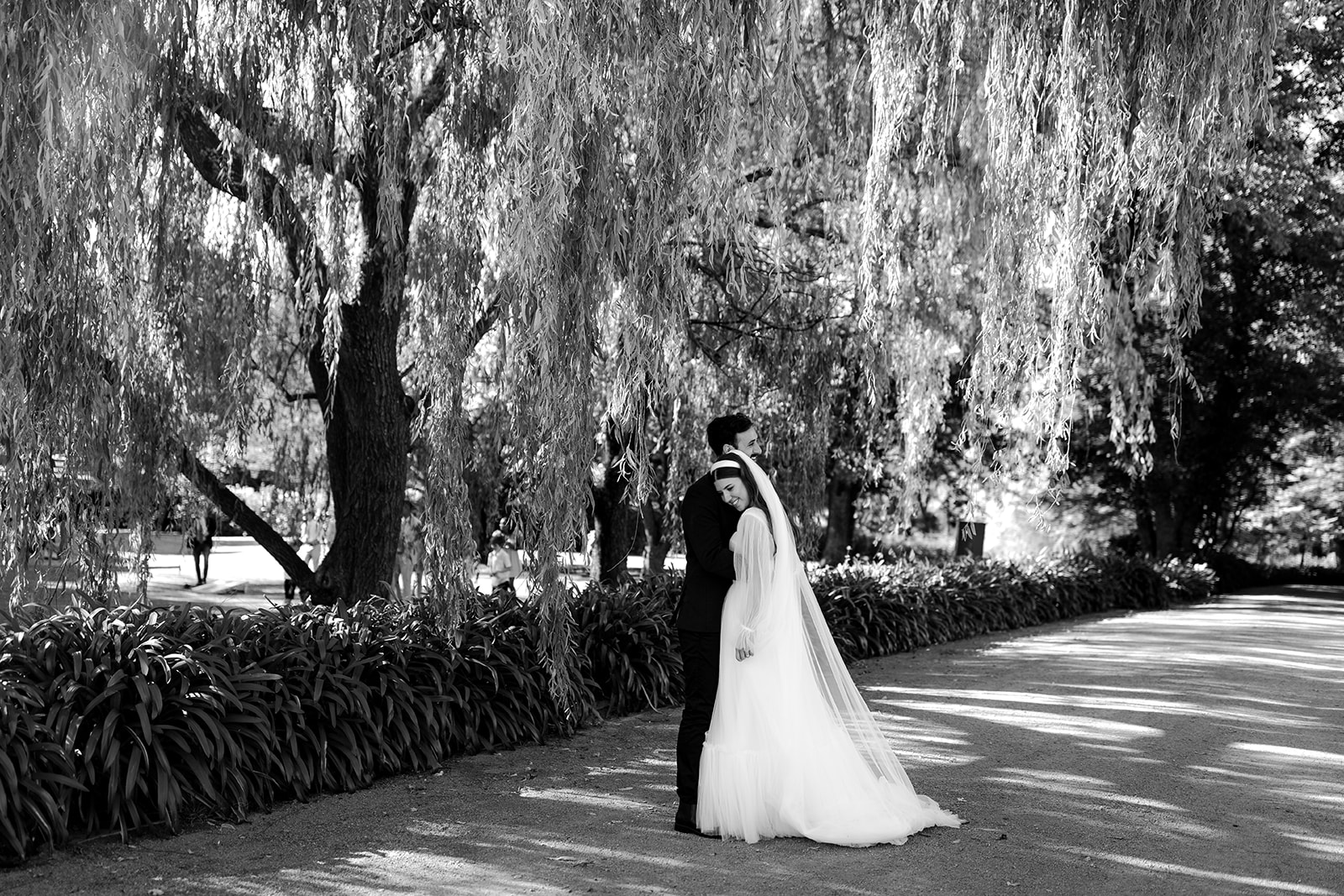 Portrait of bride & groom dancing in an English-inspired garden during their elegant country wedding.