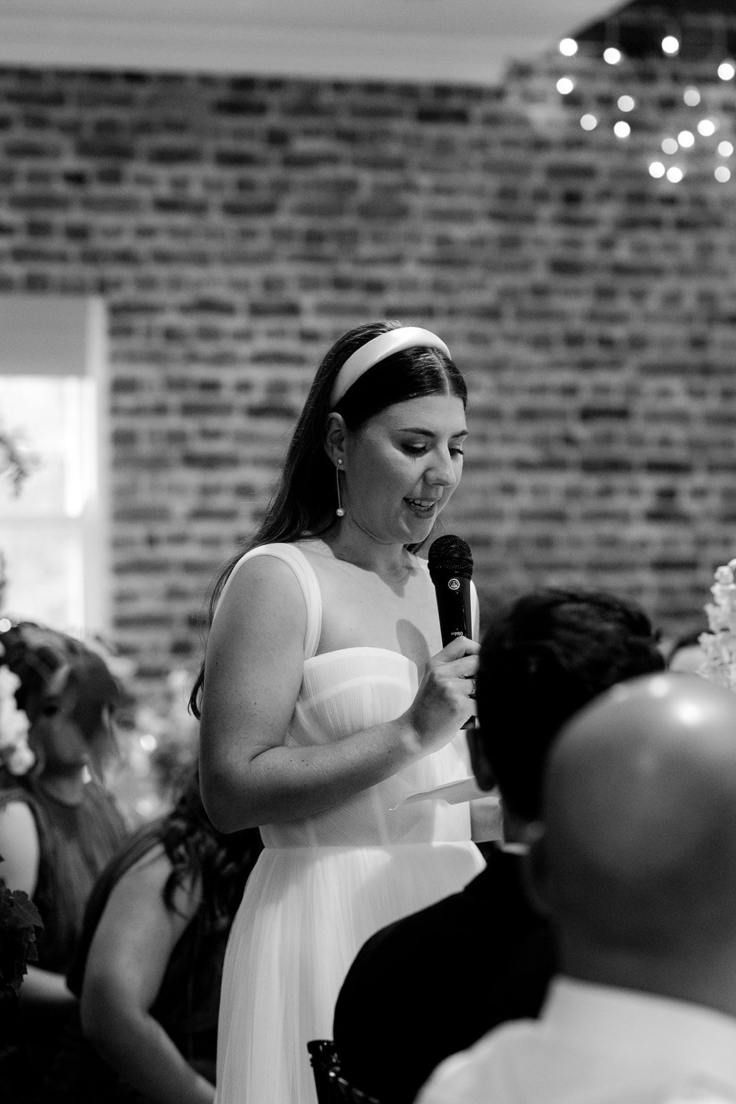 Bride making speech at her elegant country wedding reception.