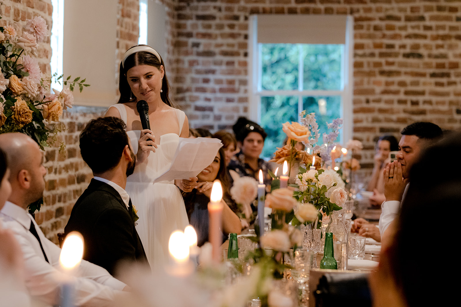 Bride making speech at her elegant country wedding reception.