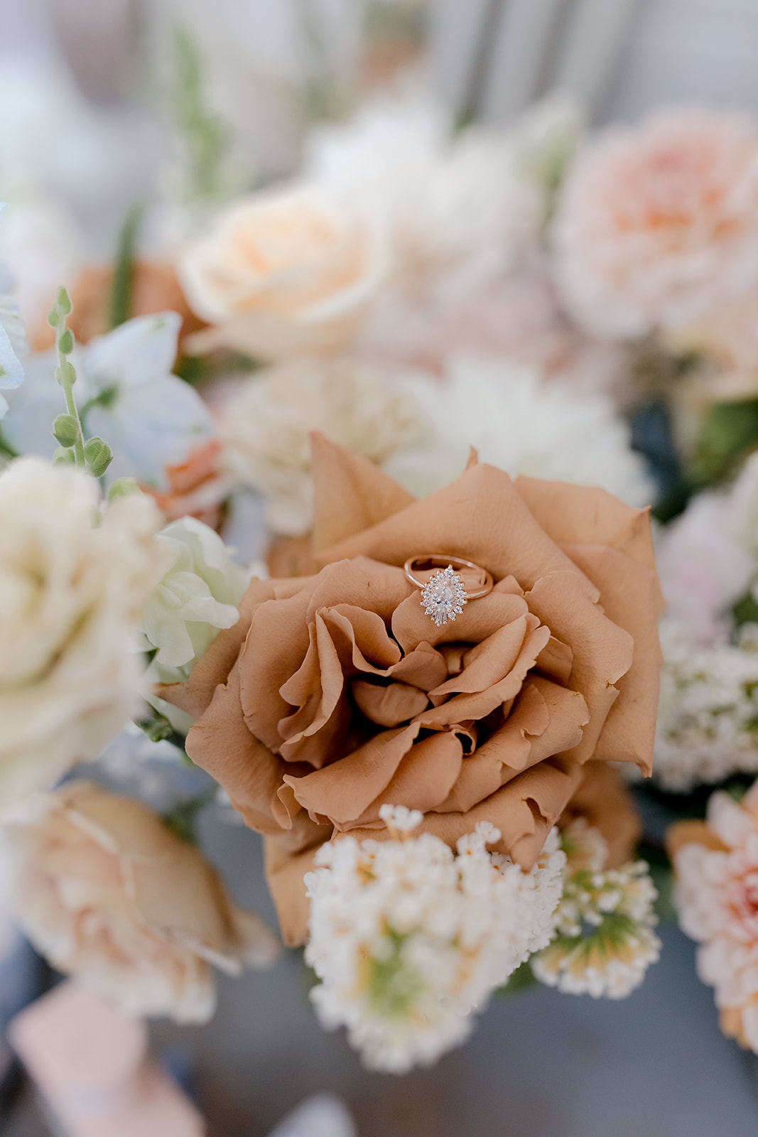 Close-up of engagement ring in bridal bouquet for an elegant country wedding.