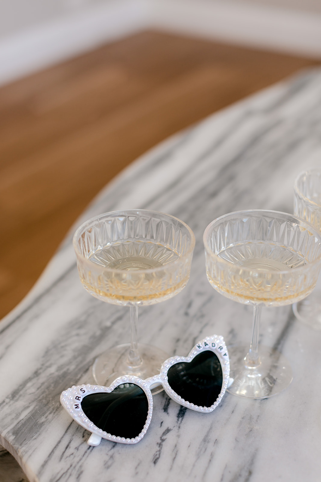 Bridal sunglasses with elegant champagne flutes.