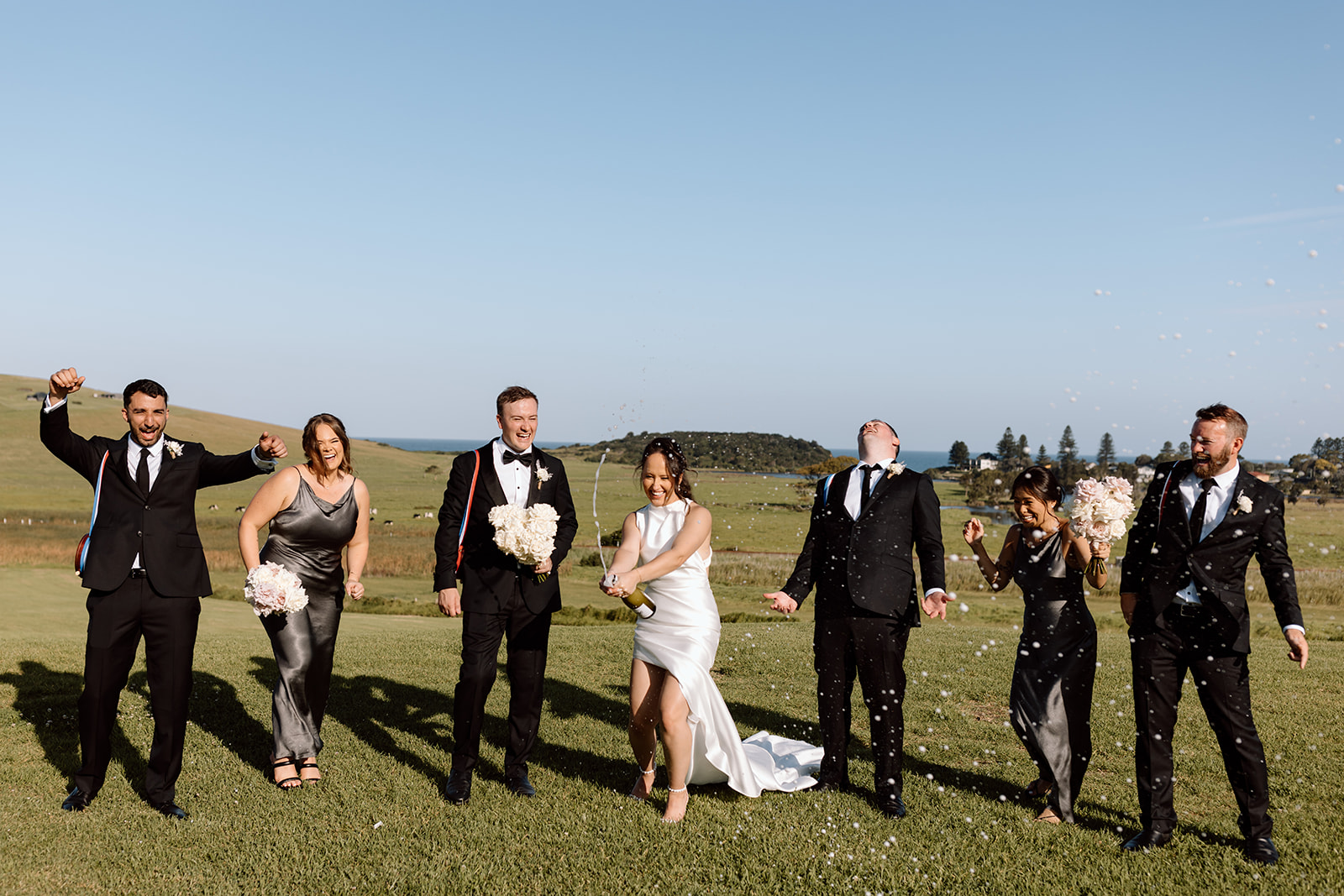 Bridal party champagne spray at the wedding in the South Coast Seacliff House