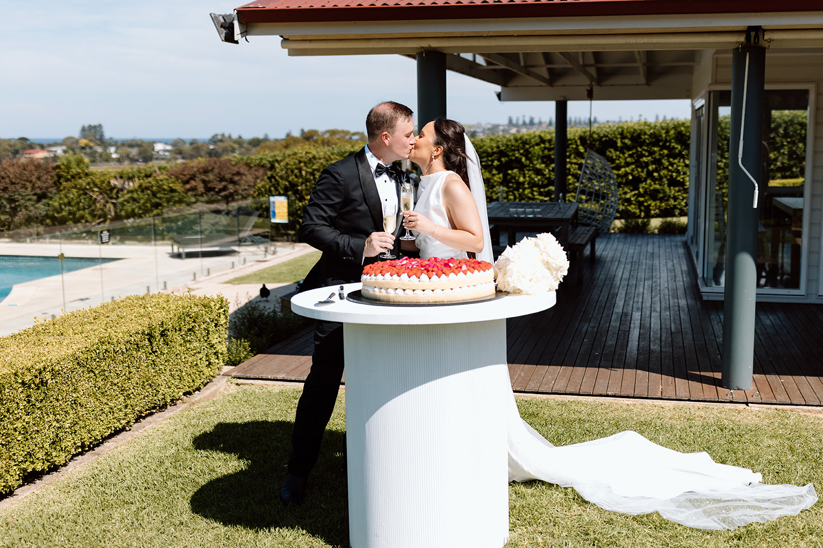 Bride and groom cutting the cake at the wedding in the South Coast Seacliff House