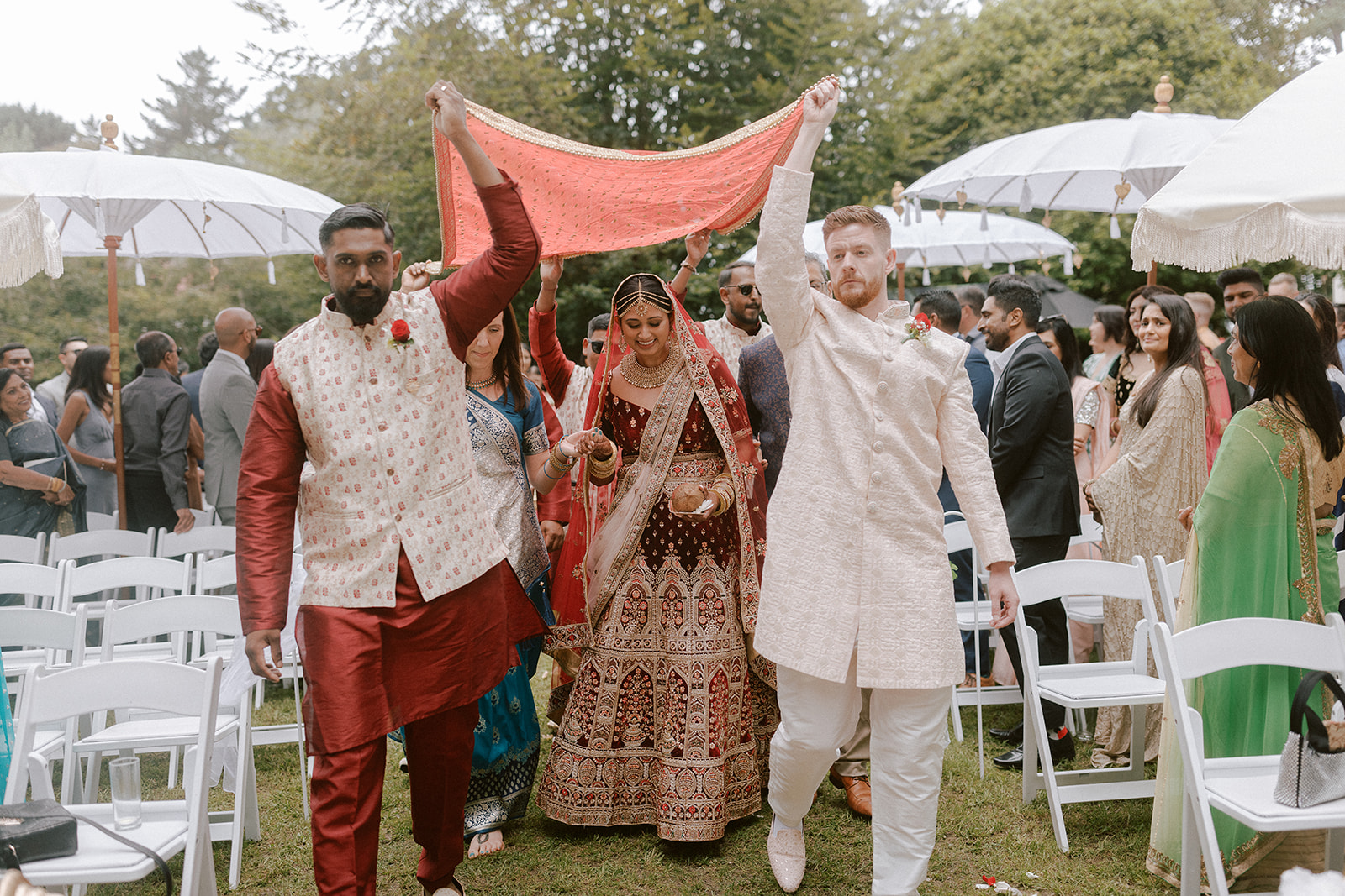 Beautiful Indian bride walking down the aisle getting married at Kumeu Valley Estate wedding venue