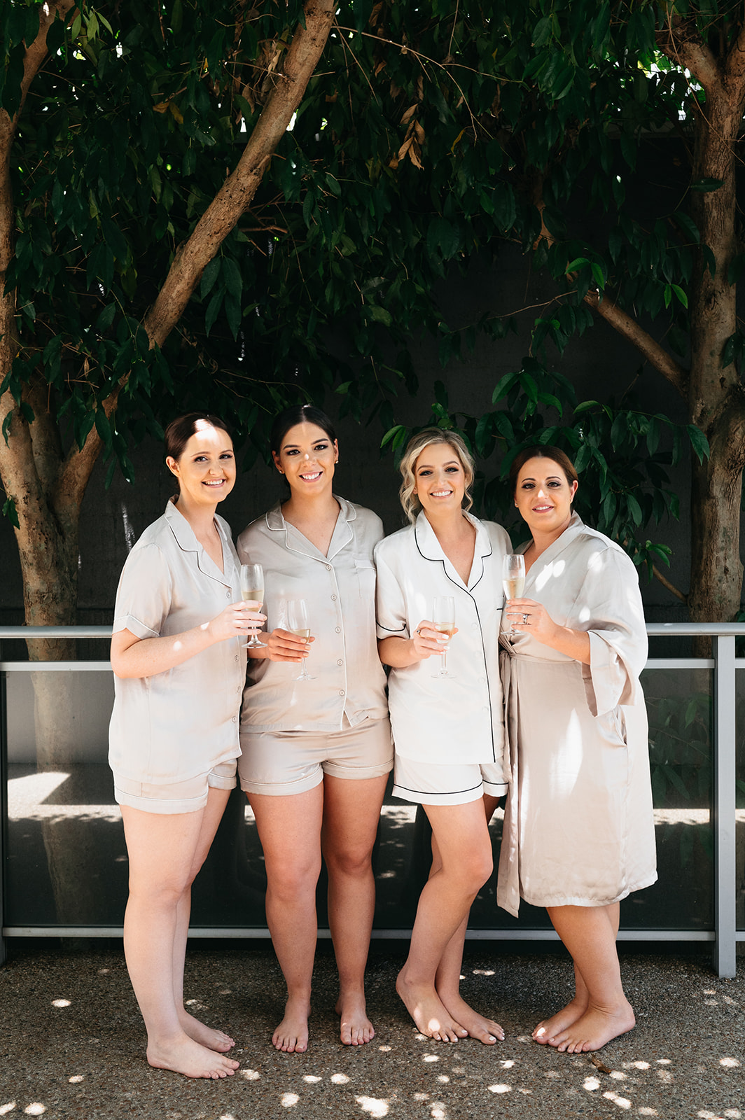 bride and bridesmaids popping champagne in Cairns