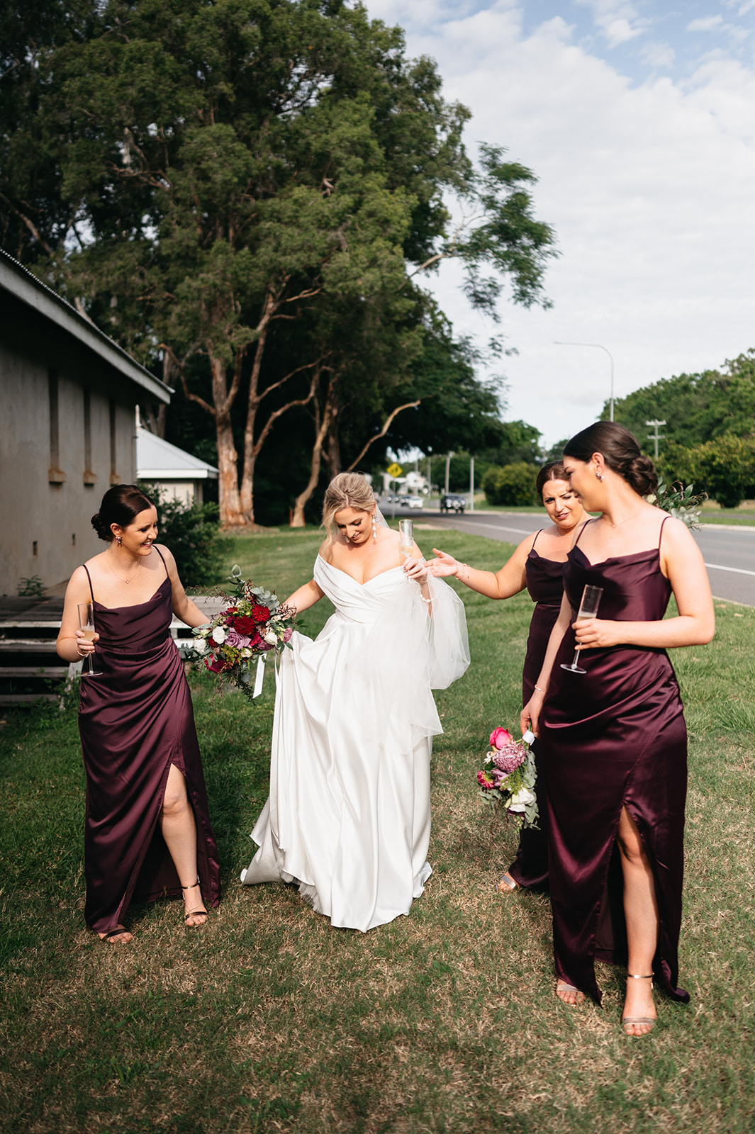 Bride and bridesmaids walking with florals in Cairns