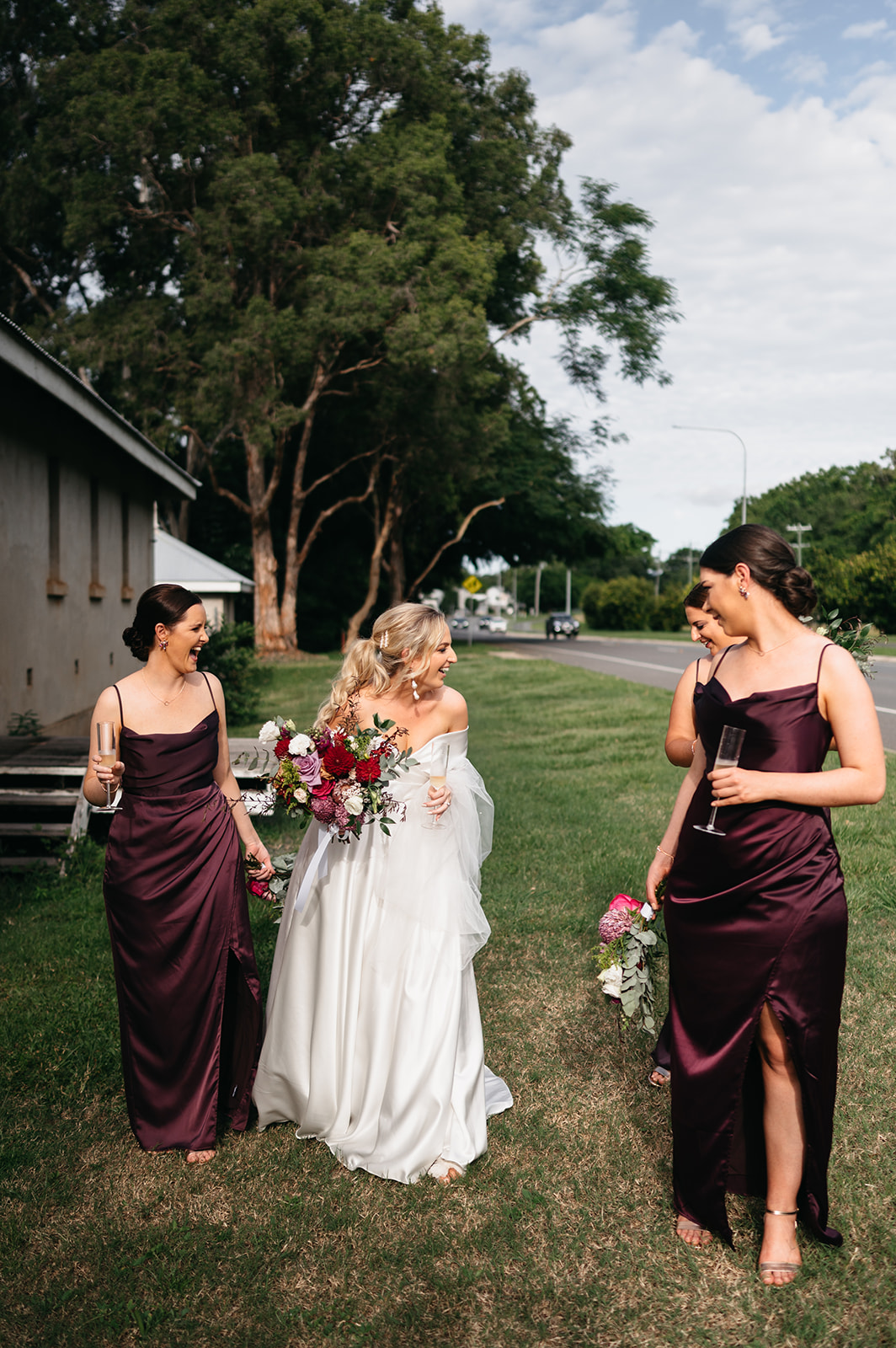 Bride and bridesmaids walking with florals in Cairns