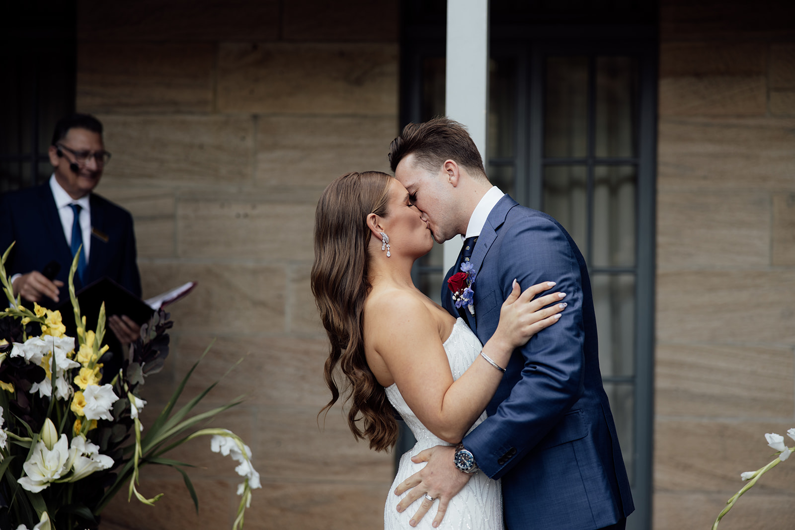 A bride and groom first kiss