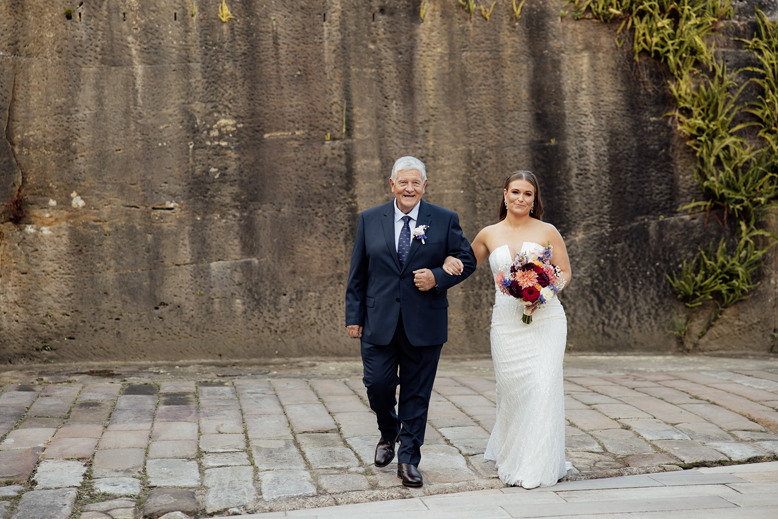 A bride and her dad walking down the isle