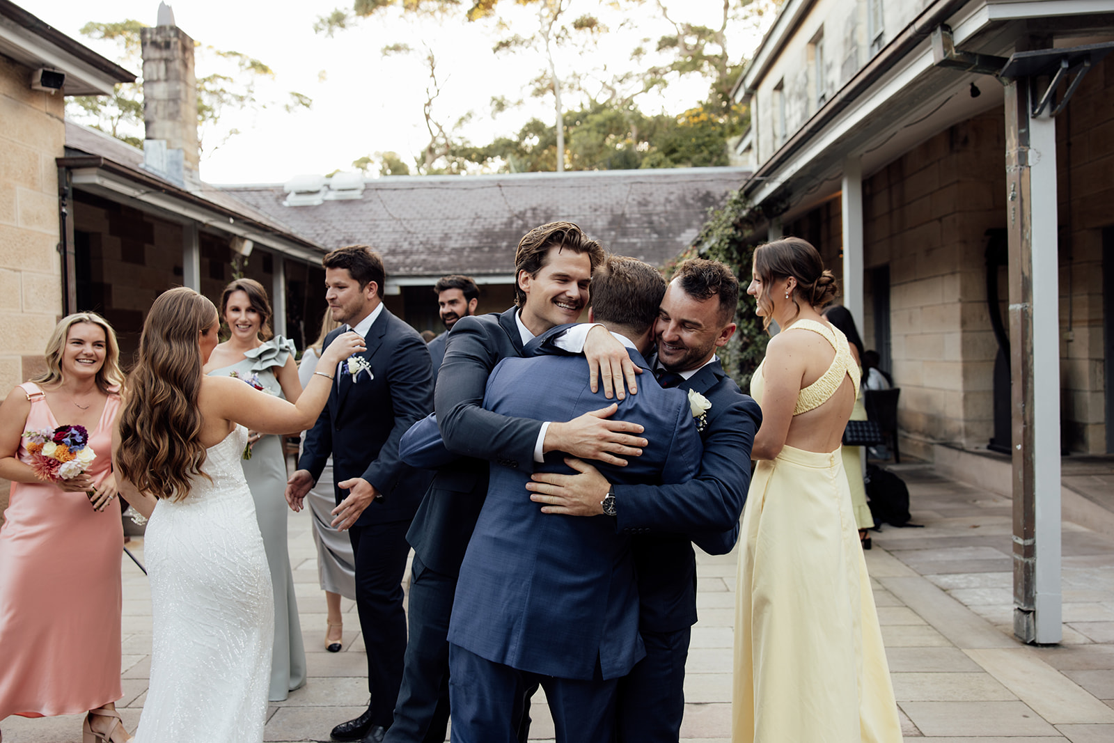 people hugging at a wedding