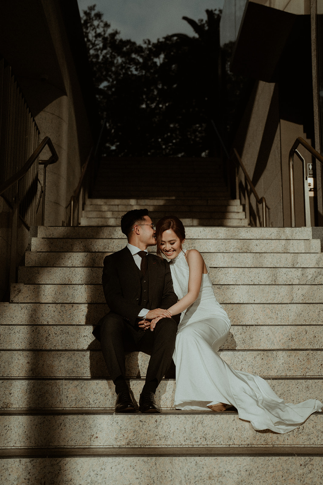 Bride and groom, kissing on the steps