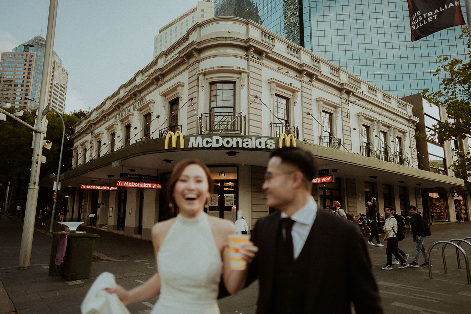 Bride and groom, walking into McDonald's