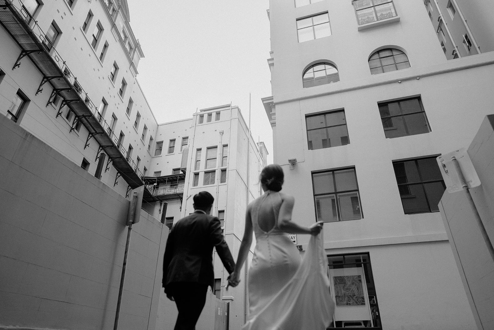 Bride and groom, walking in the middle of the city