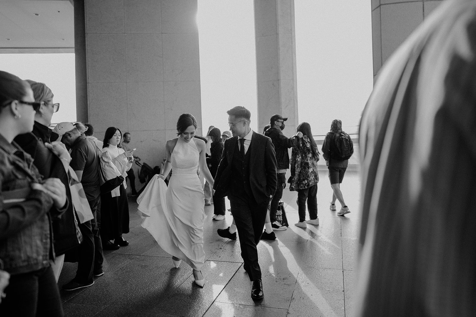 Bride and groom, walking through a crowd in Sydney city