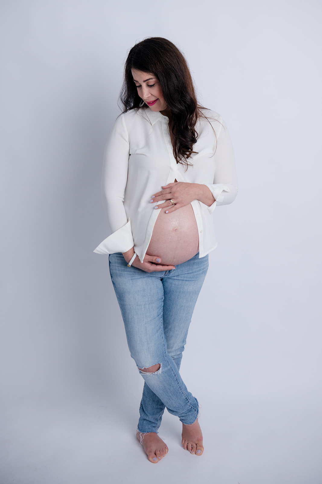 Trending studio maternity session with jeans and t-shirt