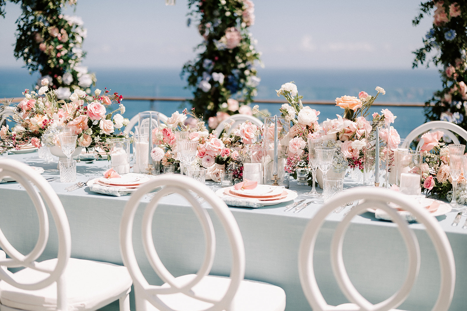 outdoor wedding table set up with flowers, by the cliffside in Uluwatu