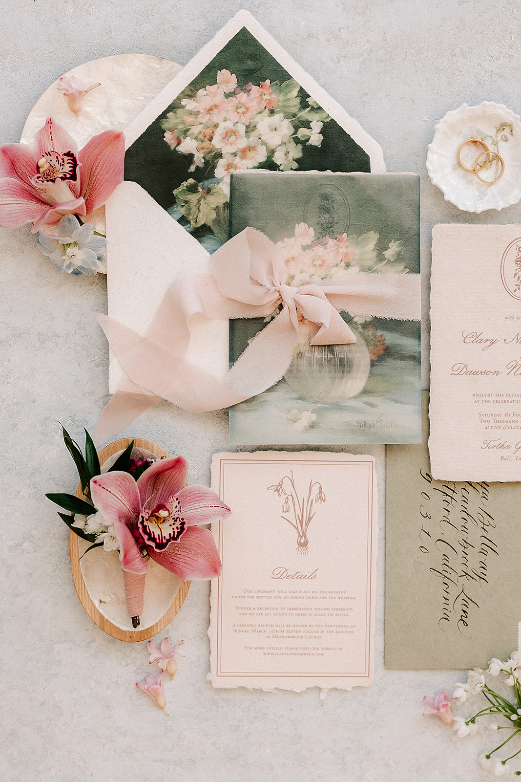wedding invitation suite and rings, photographed from above