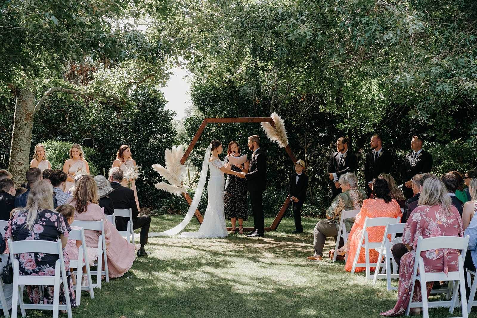 a young wedding couple get married in a lawn ceremony at tabula rasa 
