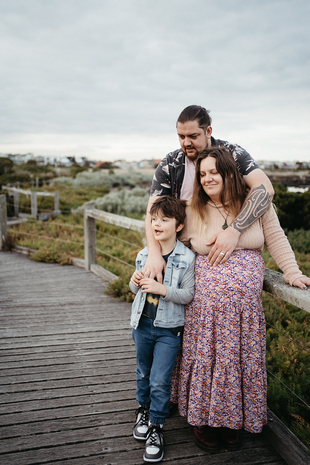 a family stand close together on a boardwalk at Jawbone Marine Sanctuary