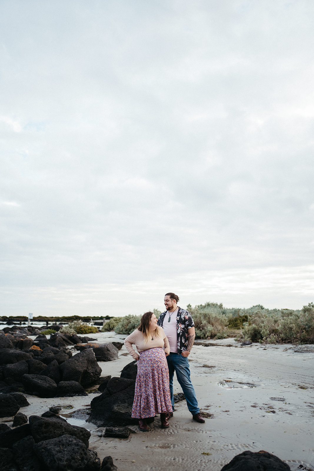a maternity couple at a beach in Williamstown