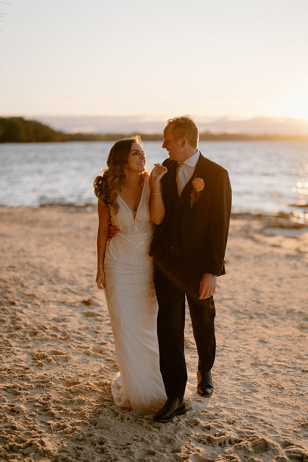 A newly wedded couple walking on the beach at sunset on their Worrowing Jervis Bay wedding.