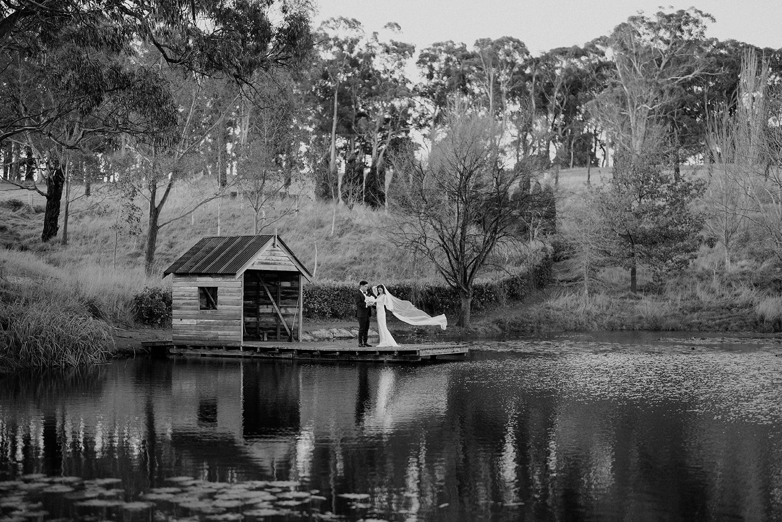 Bride and groom out by the pond at Mali Brae farm