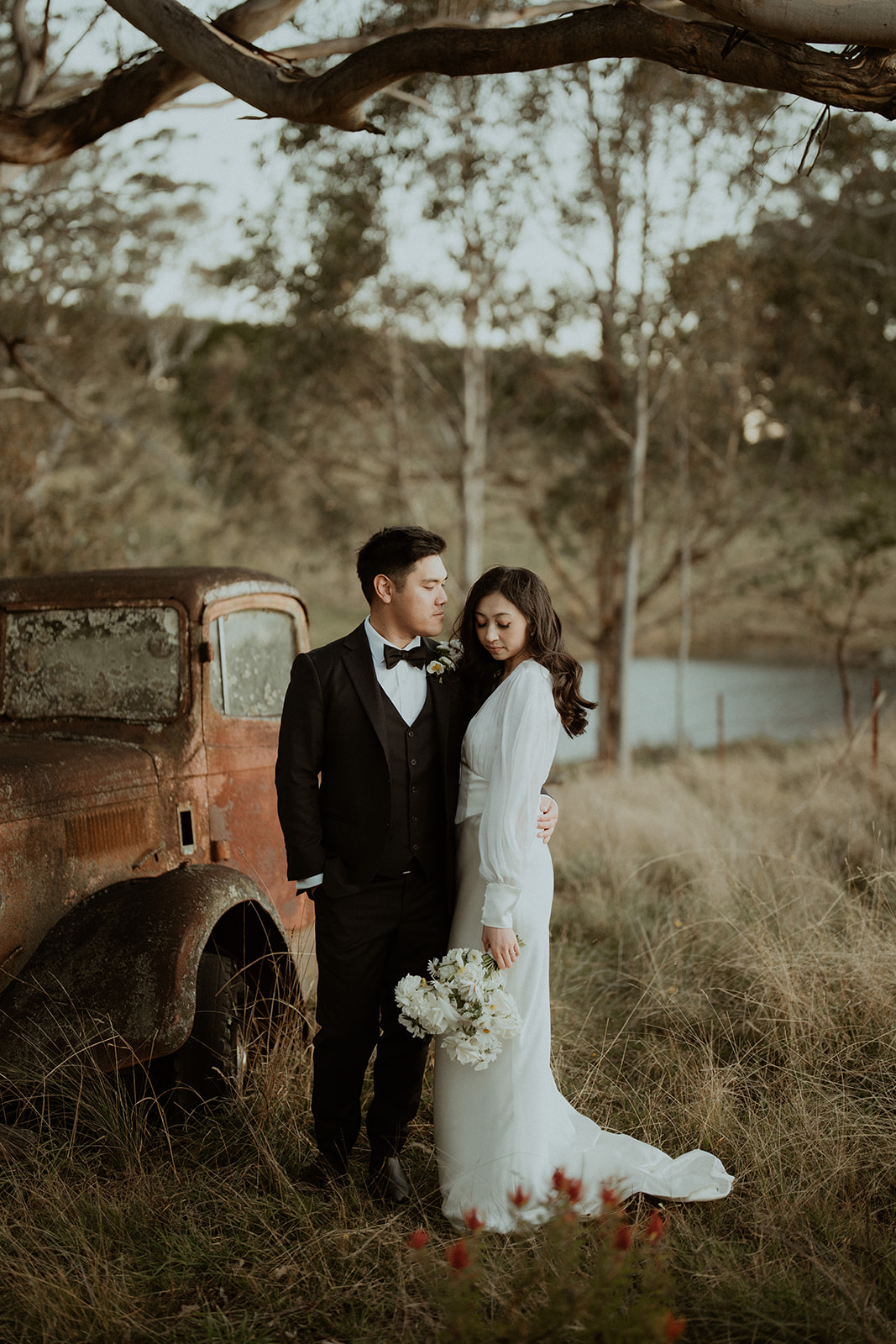 Bride and groom by the old truck at Mali Brae farm