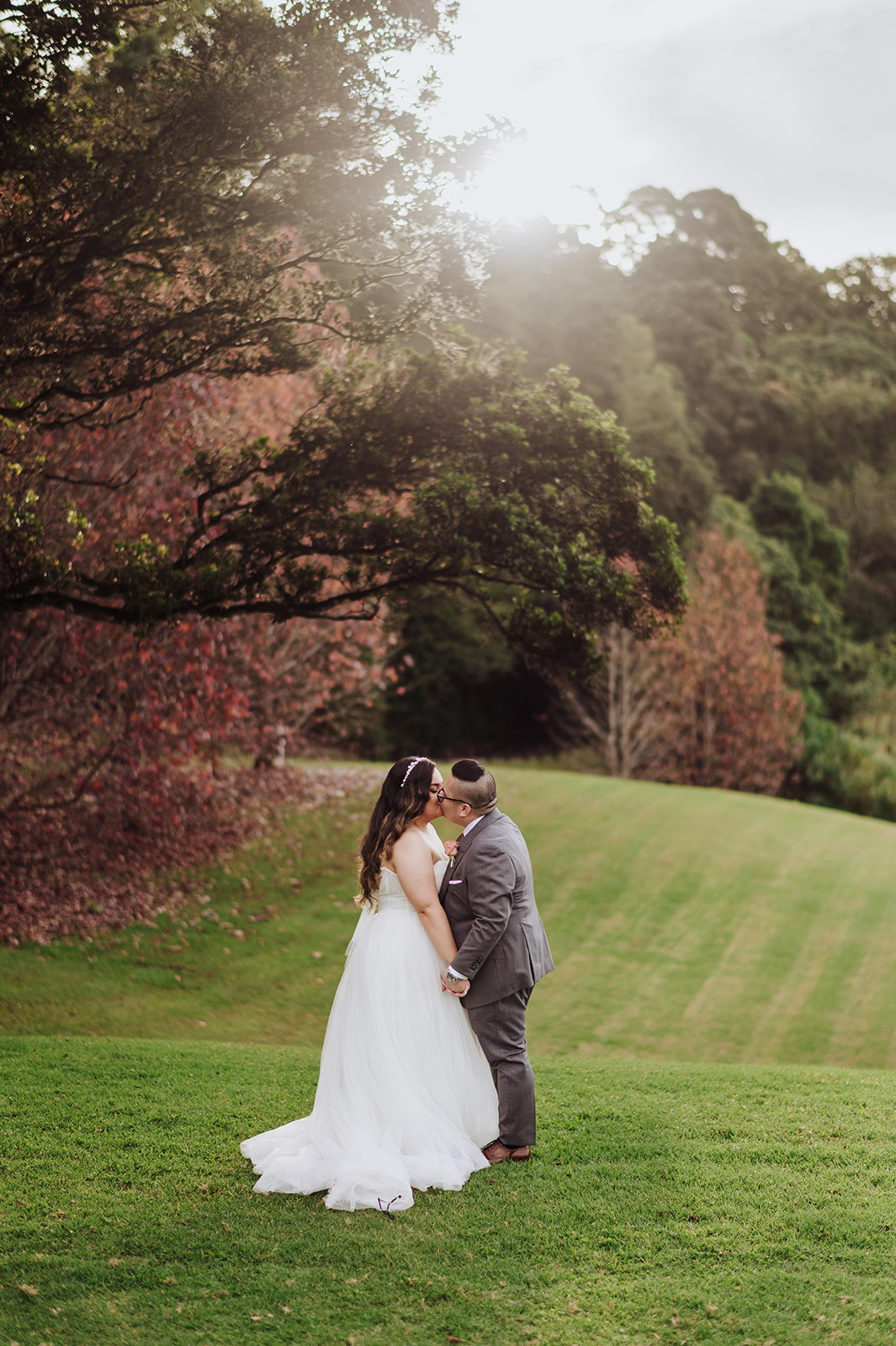 Bride and groom with autumn colours at Maleny manor