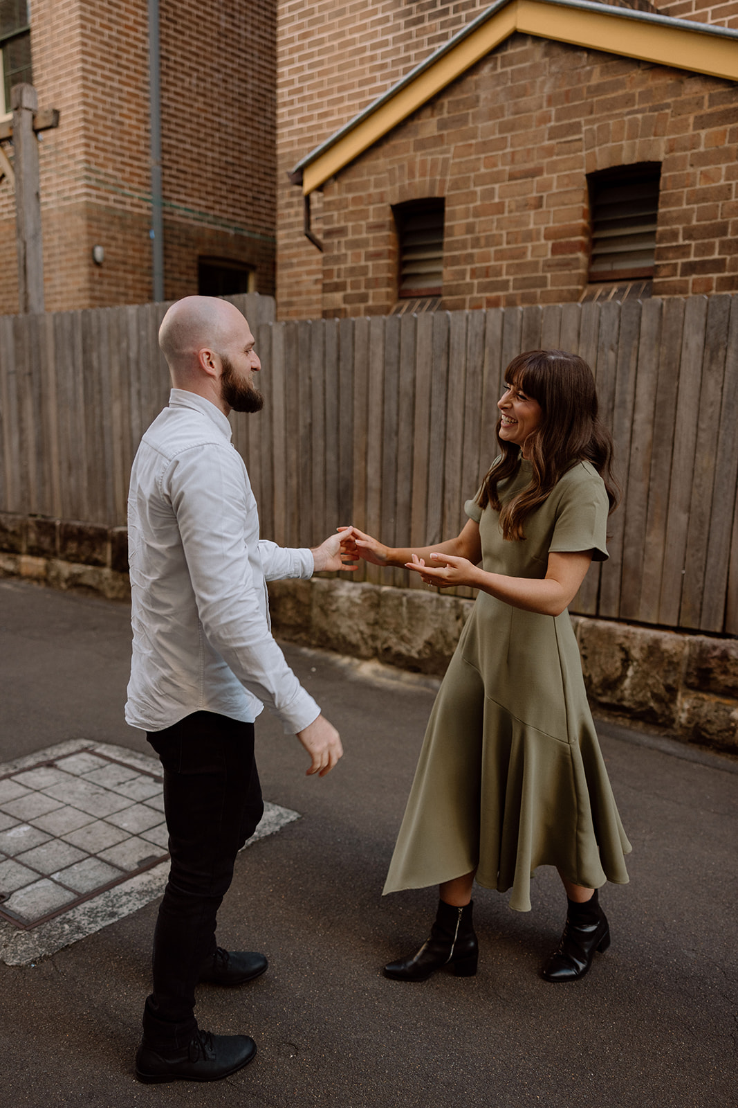 Couple happily dancing at their engagement shoot in Sydney CBD