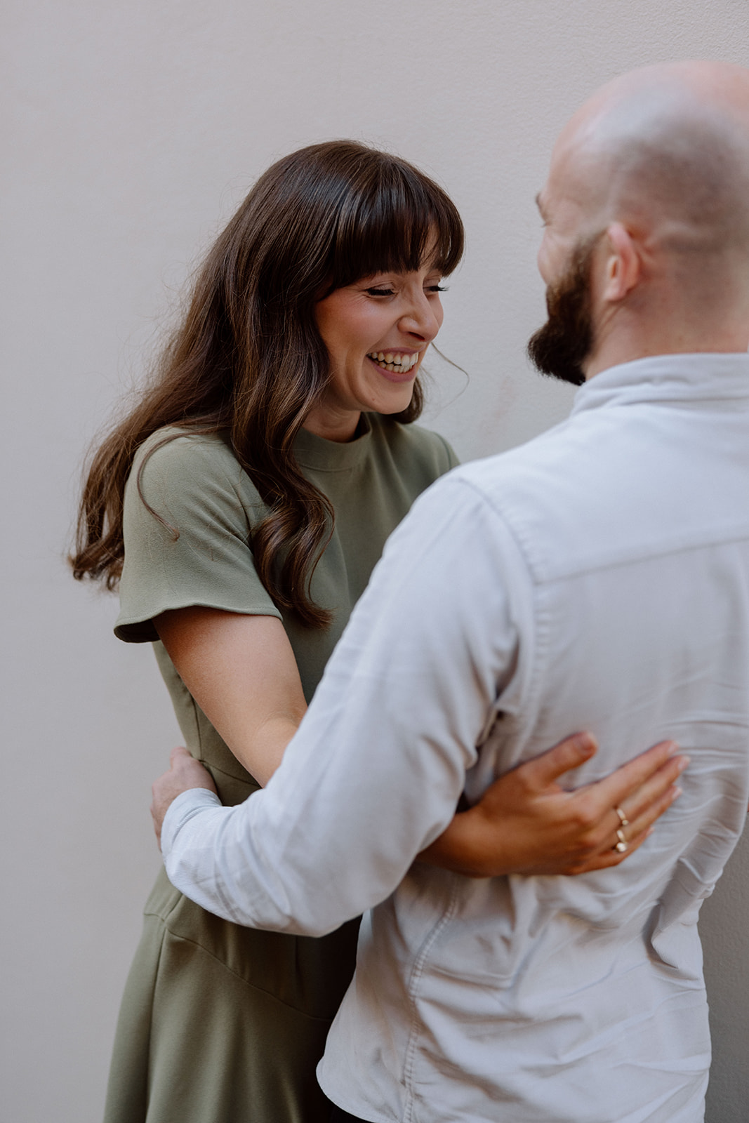 Couple laughing at each other at their engagement shoot in Sydney CBD