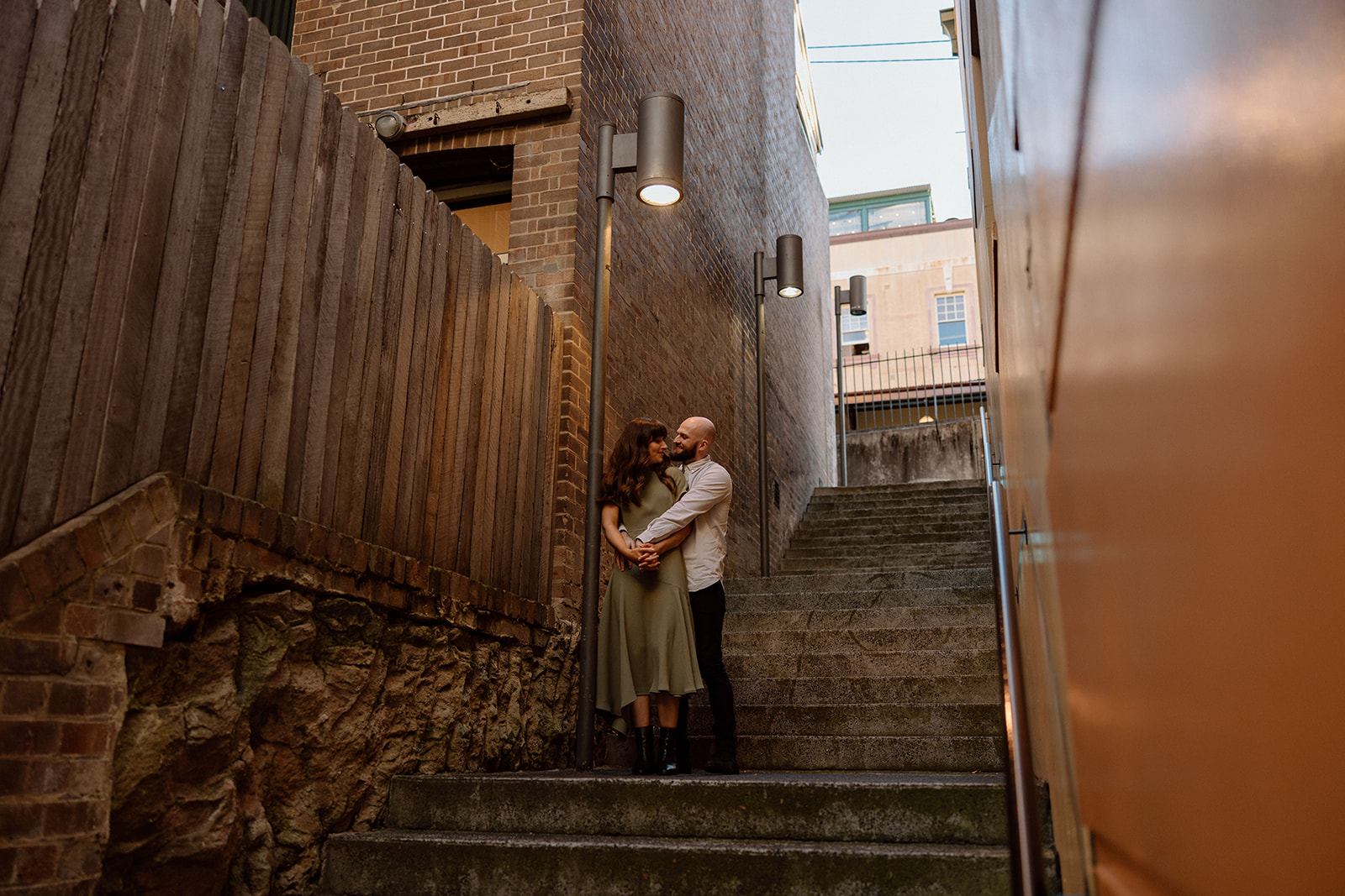 Couple looking at each other at their engagement shoot in Sydney CBD